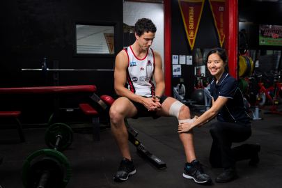 Shi Hui Wong at West Adelaide Football Club taping knee