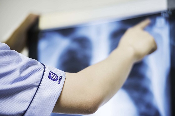 A student is pointing at a CT image.