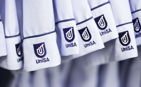 Nursing uniforms with the UniSA logo.
