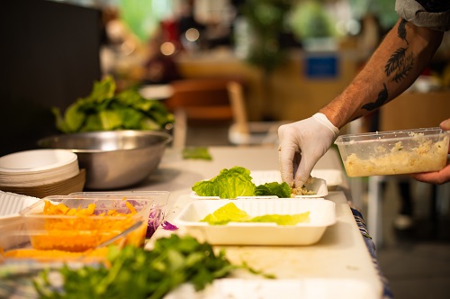 Young man preparing food samples at UniSA health food market