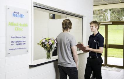 Student helping patient at Magill Health Clinic