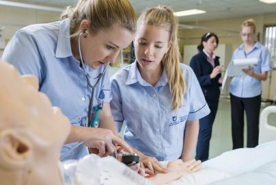 Nursing students using the campus interactive manikins